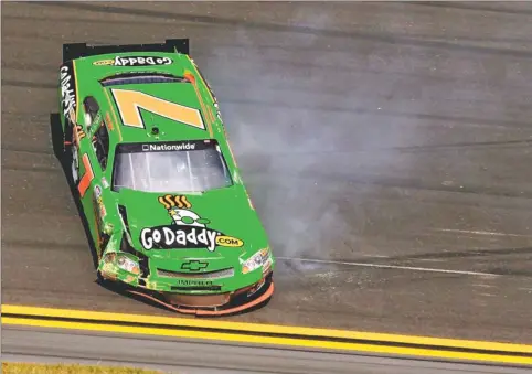  ?? By Bill Friel, AP ?? Crash course: Danica Patrick’s car slides down the track after crashing during the Nationwide Series race at Daytona. Patrick, the pole-sitter, finished 38th.