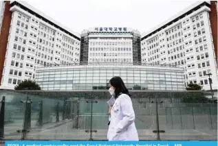  ?? ?? SEOUL: A medical worker walks past the Seoul National University Hospital in Seoul. – AFP