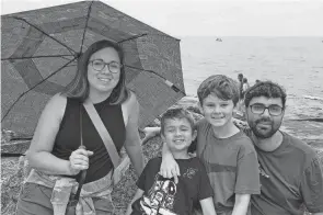  ?? ?? Katie and Peter Mang take a portrait with their children Elliott, 7, and Owen, 11, earlier this year on the beach at Marblehead.