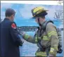  ??  ?? Lt. Dennis Relyea finishes his 110stories for the CNY Memorial Stair Climb and pins a badge on the wall for someone who died in the September 11attack on Saturday, Sept. 7, 2019.