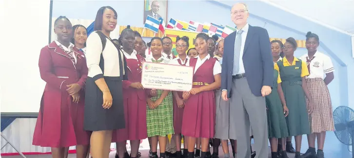  ??  ?? State Minister Alando Terrelonge (centre) with SJF president Josep Bosch (fourth left) and other heads of Spanish-speaking missions in Kingston. CSEC cheque handover: Josep Bosch, Spanish Jamaica Foundation president, and Patricia Mumby Lalor from the Ministry of Education pose with students at the the Sam Sharpe Teachers’ College.