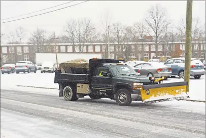  ?? Cassandra Day / Hearst Connecticu­t Media ?? A private plow operator clears snow from the Suburban Stationers parking lot on High Street on Tuesday afternoon.