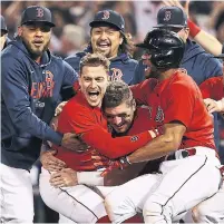  ?? WINSLOW TOWNSON GETTY IMAGES ?? Red Sox teammates mob Kiké Hernandez after his game-winning sac fly, clinching their series against the Rays.