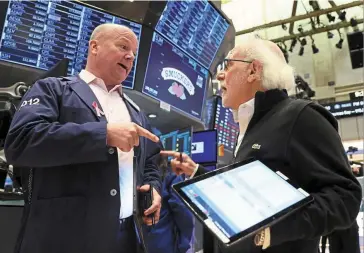  ?? ?? Close call: Traders work on the floor of the New York Stock Exchange. Investors’ focus has largely shifted to the Fed and the pace at which it will continue raising interest rates as it attempts to bring inflation down from near 40-year highs. — Reuters