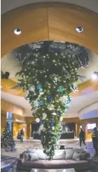  ?? CP PHOTO BY DARRYL DYCK ?? An upside-down Christmas tree is seen suspended from the ceiling at the Fairmont Vancouver Airport hotel in Richmond, B.C. on Monday.