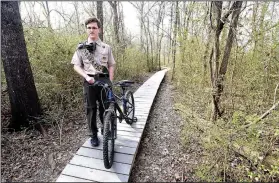  ?? NWA Democrat-Gazette/FLIP PUTTHOFF ?? Mason Walker shows a platform that’s part of a mountain bike trail at Rogers New Tech High School he built for his Eagle Scout project. Several Scouts, friends, parents and others helped with the work.