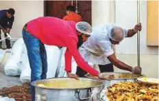  ??  ?? Kumar said: ‘No other month equals the spirit of giving as Ramadan. There is compassion and sharing. There is a feel of community in places like these.’ In this image, volunteers are preparing to distribute food.