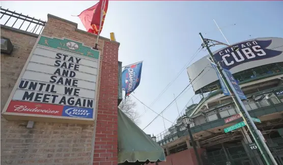  ?? JONATHAN DANIEL/GETTY IMAGES ?? A sign on the wall of Murphy’s Bleachers across the street from Wrigley Field sadly says it all. The Cubs’ home opener was scheduled for March 30.