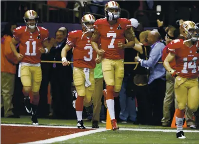  ?? NHAT V. MEYER — BAY AREA NEWS GROUP FILE ?? San Francisco 49ers starting quarterbac­k Colin Kaepernick (7) leads his teammates onto the field before the start of Super Bowl XLVII against the Baltimore Ravens on Sunday, Feb. 3, 2013, at the Superdome in New Orleans.