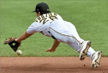  ?? Matt Freed/ Post- Gazette ?? Second baseman Adam Frazier dives for a ball hit by Chicago’s Victor Caratini Thursday at PNC Park.