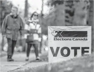  ?? NATIONAL POST ?? People arrive at a polling station in Mississaug­a, Ont., to vote in the federal Canadian election on Oct. 21, 2019.