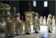  ?? REMO CASILLI — POOL PHOTO VIA AP ?? Cardinals and bishops attend the Easter Vigil celebrated by Pope Francis April 3 in St. Peter’s Basilica.