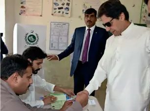  ?? Courtesy Twitter ?? Prime Minister Imran Khan casts his vote at a polling booth in Islamabad. —