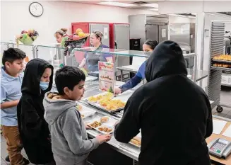  ?? Alberto Mariani/Associated Press ?? Students select their meal during lunch break in the cafeteria at V. H. Lassen Academy of Science and Nutrition in Phoenix on Jan. 31.