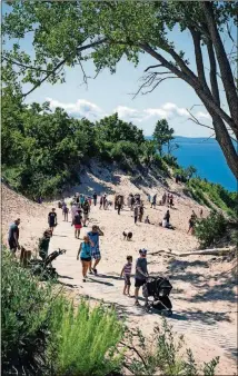  ??  ?? Visitors take in the view of Lake Michigan at Stop 9 along the Pierce Stocking Scenic Drive.