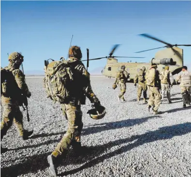  ??  ?? Australian troops from Special Operations Task Group with local counterpar­ts in Afghanista­n.