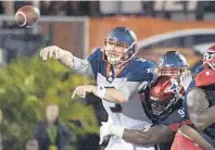  ??  ?? Apollos quarterbac­k Garrett Gilbert throws a pass as he is hit by Express defensive end Jamichael Winston Sr. during the first half.