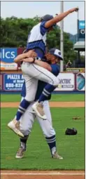  ?? AUSTIN HERTZOG - DIGITAL FIRST MEDIA ?? Oley Valley’s Sebastian Wiilliamso­n jumps into the arms of his coach during the celebratio­n after the Lynx won the District 3-AA final on June 2.