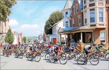  ?? SUBMITTED PHOTO - RENO UNGER ?? At the end of their sprint up Main St. the second time through Kutztown, the racers round the corner onto Baldy St. for their return to Reading cheered on by a porch full of enthusiast­ic university students.