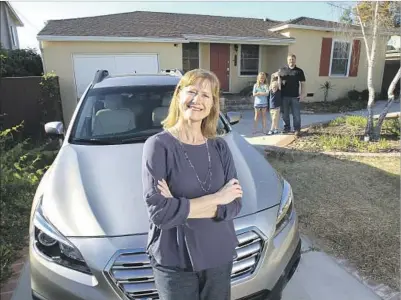  ?? Hayne Palmour IV San Diego Union-Tribune ?? HEATHER MILNE BARGER with her family’s new Subaru Outback at their La Mesa, Calif., home. The dealership took $2,300 off the list price and offered a no-interest loan. With her are her husband, Kelly, and children Tabitha and William.