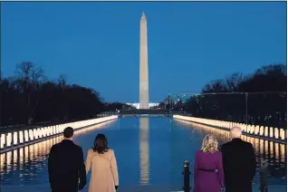  ?? Evan Vucci / Associated Press ?? President-elect Joe Biden and his wife, Jill Bid,en are joined by Vice President-elect Kamala Harris and her husband, Doug Emhoff, during a COVID-19 memorial event at the Lincoln Memorial Reflecting Pool on Tuesday in Washington.