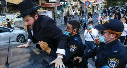  ?? ( Marc Israel Sellem/ The Jerusalem Post) ?? POLICE IN Jerusalem detain a haredi protester last week.