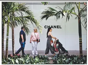  ?? Bloomberg file photo ?? Shoppers pass in front of a Chanel store in Miami early this year. The French fashion house published financial results Thursday for the first time in its 108-year history.