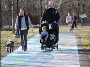  ?? SUBMITTED PHOTO ?? A family enjoys a stroll on the mosaic painted on the Schuylkill river Trail in Pottstown’s Riverfront Park.