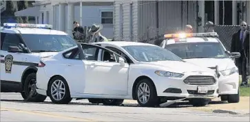  ?? Greg Wohlford Erie Times-News ?? POLICE in Erie, Pa., block a car belonging to Steve Stephens, the suspect in the killing of an elderly stranger in Cleveland on Sunday. Authoritie­s said Stephens shot and killed himself in his car after a brief chase.