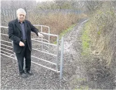  ??  ?? Roy Chetham next to the vandalised kissing gate and fence off Altham Lane in Huncoat