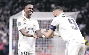  ?? ?? Karim Benzema (derecha) del Real Madrid celebra con Vinicius Junior tras marcar el primer gol ante Liverpool en el duelo de octavos de final de la Liga de Campeones.