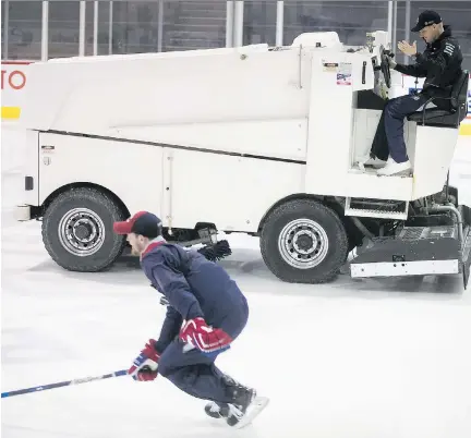  ?? PIERRE OBENDRAUF ?? Formula One driver Valtteri Bottas tries to power a Zamboni past a skating Paul Byron on Wednesday as the two took to the ice at the Canadiens’ practice rink in Brossard. Bottas, who played hockey while growing up in Finland, finished third in last...