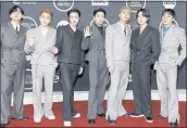  ?? JORDAN STRAUSS — INVISION /VIA AP ?? BTS poses in the press room after winning the awards for favorite pop duo or group, favorite pop song for “Butter” and artist of the year at the American Music Awards on Sunday at Microsoft Theater in Los Angeles.