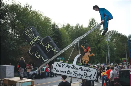  ?? The Canadian Press ?? A caricature of Prime Minister Justin Trudeau is seen during a protest against the Trans Mountain pipeline and a rally calling for the protection of Stoney Creek, in Burnaby.