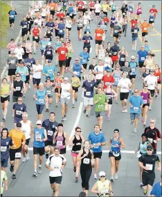  ?? — Telegram file photo/Keith Gosse ?? In this July 22, 2013 file photo, a pack of runners moves along Topsail Road during the 2013 running of the Telegram 10-Mile Road Race. The organizing committee for the Tely 10 has decided to cap race registrati­on at 4,200, saying it’s needed to ensure...