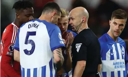  ?? ?? Players surround referee Anthony Taylor after Lewis Dunk’s red card for Brighton on Saturday. Photograph: Matthew Childs/Action Images/Reuters