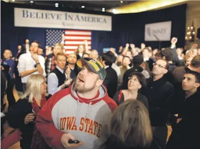  ?? CHIP SOMODEVILL­A/GETTY IMAGES ?? Supporters and volunteers of Mitt Romney follow the news on the television during a rally at the Hotel Fort Des Moines.