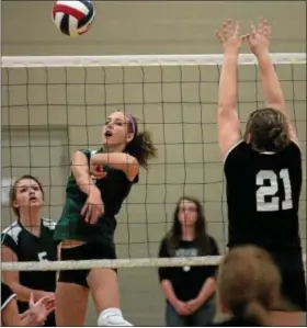  ?? Montgomery Media / BOB RAINES ?? Christophe­r Dock’s Lanae Hunsberger spikes past Faith Christian’s Kelsey Mikula during Tuesday’s match.