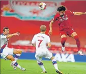  ??  ?? Mohamed Salah (right) heads the ball above Crystal Palace midfielder Max Meyer (centre) at Anfield. Liverpool is a team as close to perfection as it gets. They have crafted a legend out of skill, effort, camaraderi­e and belief. AFP