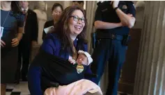  ?? Tribune News Service/getty Images ?? U.S. Sen. Tammy Duckworth (D-illinois) leaves the Senate Chamber after a vote with her newborn baby daughter Maile Pearl Bowlsbey at the U.S. Capitol on Take Your Daughters and Sons To Work Day, April 26, 2018 in Washington, D.C.