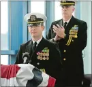  ??  ?? Lt. Cmdr. Reginald Preston is applauded by Deputy Command Chaplain Rob Guilliams after his remarks during the change of charge ceremony.