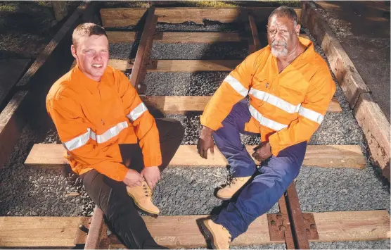  ?? Picture: EVAN MORGAN ?? LINING UP: Aaron Livock and Elemo Tapim have completed a Certificat­e II in Rail Infrastruc­ture at the Townsville Business Developmen­t Centre.