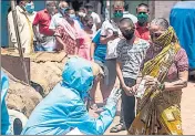  ??  ?? Health workers conduct Covid-19 tests in Dharavi, a slum in Mumbai and a major hot spot, in May. SATYABRATA TRIPATHY/HT PHOTO