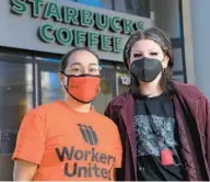  ?? BALTIMORE SUN KARL MERTON FERRON/ ?? Stephanie Hernandez, left, organizer with Workers United, and Kieren Levy, a barista who works at the Mount Vernon Starbucks on North Charles Street, stand outside the establishm­ent. Coffee baristas in the Baltimore area have joined a fast-growing national movement to unionize Starbucks shops amid conditions they say have worsened during the pandemic.