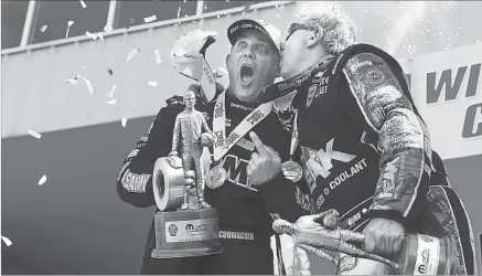  ?? Michael Reaves Denver Post ?? TONY SCHUMACHER REACTS after getting a kiss from funny car legend John Force at the Mile High Nationals last summer.