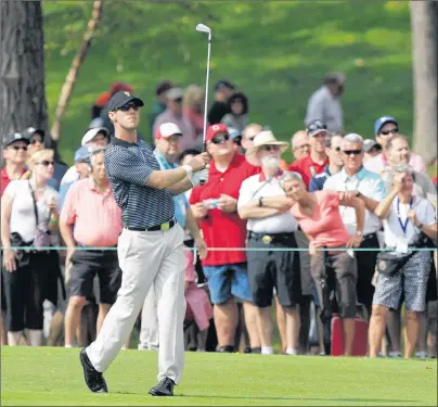  ?? CP PHOTO ?? Internatio­nal team player Graham DeLaet of Canada hits his approach shot on the first hole during a foursome match against the United States at the Presidents Cup golf tournament at Muirfield Village Golf Club in 2013, in Dublin, Ohio. A recent study...