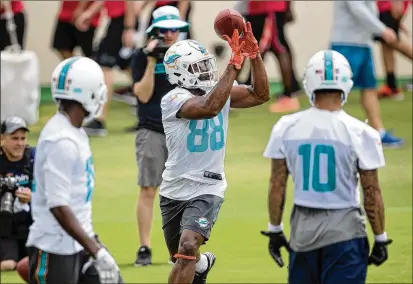  ?? ALLEN EYESTONE / THE PALM BEACH POST ?? Second-year wide receiver Leonte Carroo (88) drops a pass during Dolphins minicamp practice Wednesday at Nova Southeaste­rn University in Davie. Carroo’s roster spot reportedly could be in jeopardy at training camp this summer.