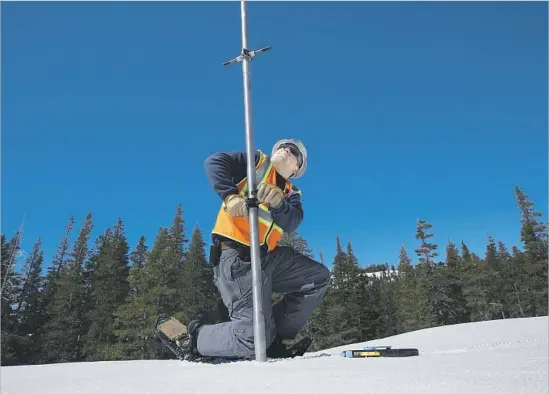  ?? Rich Pedroncell­i Associated Press ?? TONY OROZCO, a hydrograph­er for Pacific Gas & Electric Co., uses a snow sampler in Nevada County, Calif. The survey method has remained unchanged for decades.