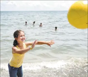  ?? Hearst Connecticu­t Media file photo ?? Nine-year-old Jensen Gutzwiller, of Westport, plays a game of monkey-in-the-middle while other Camp Compo campers stay cool in the water on July 9, 2010, at Compo Beach in Westport.