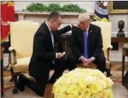  ?? ACQUELYN MARTINT— THE ASSOCIATED PRESS ?? President Donald Trump prays with American pastor Andrew Brunson in the Oval Office of the White House, Saturday October 13, 2018, in Washington. Brunson returned to the U.S. around midday after he was freed Friday, from nearly two years of detention in Turkey.